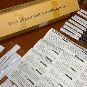 25 piece knife set. Black handled. Injector set and sharpener included.